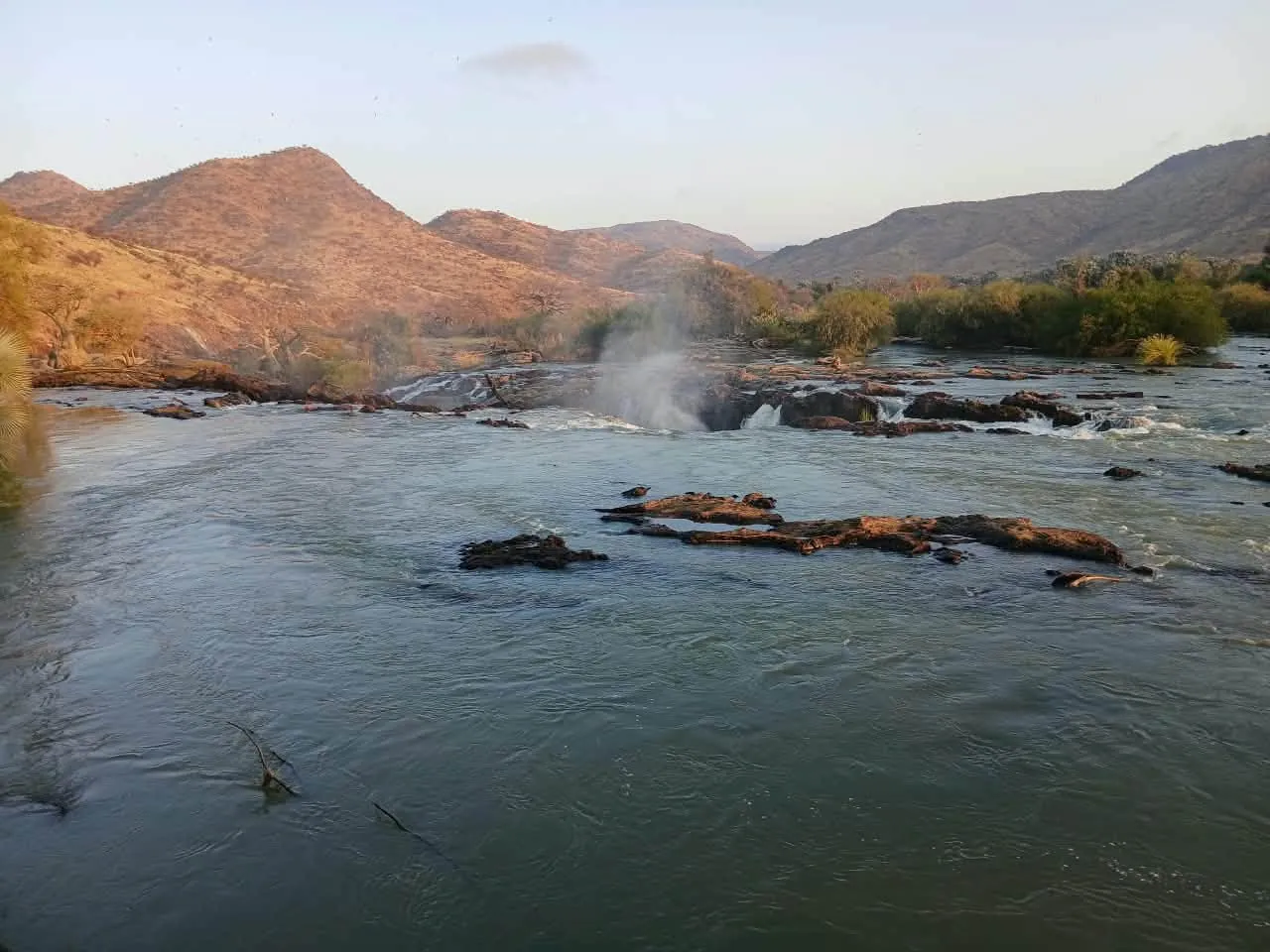 The Kunene River pouring over the rocks at Epupa Falls
