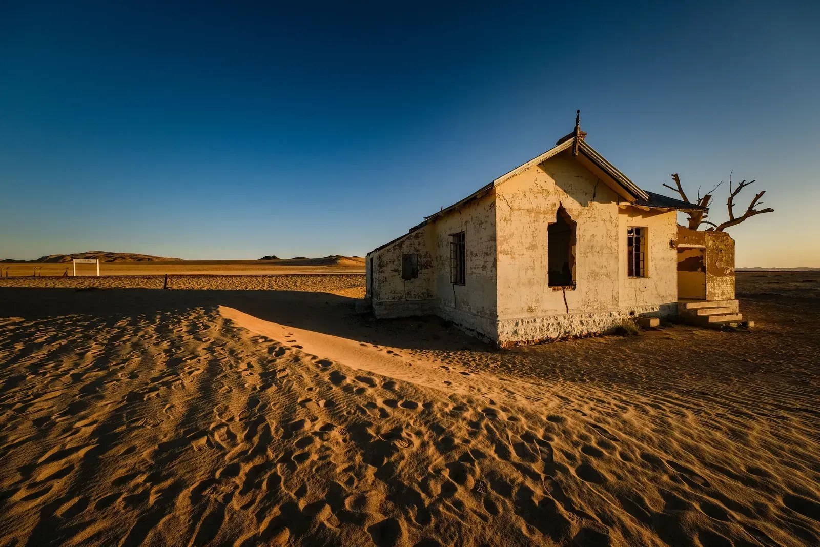 A diamond-era house left to the sand, glowing at last light
