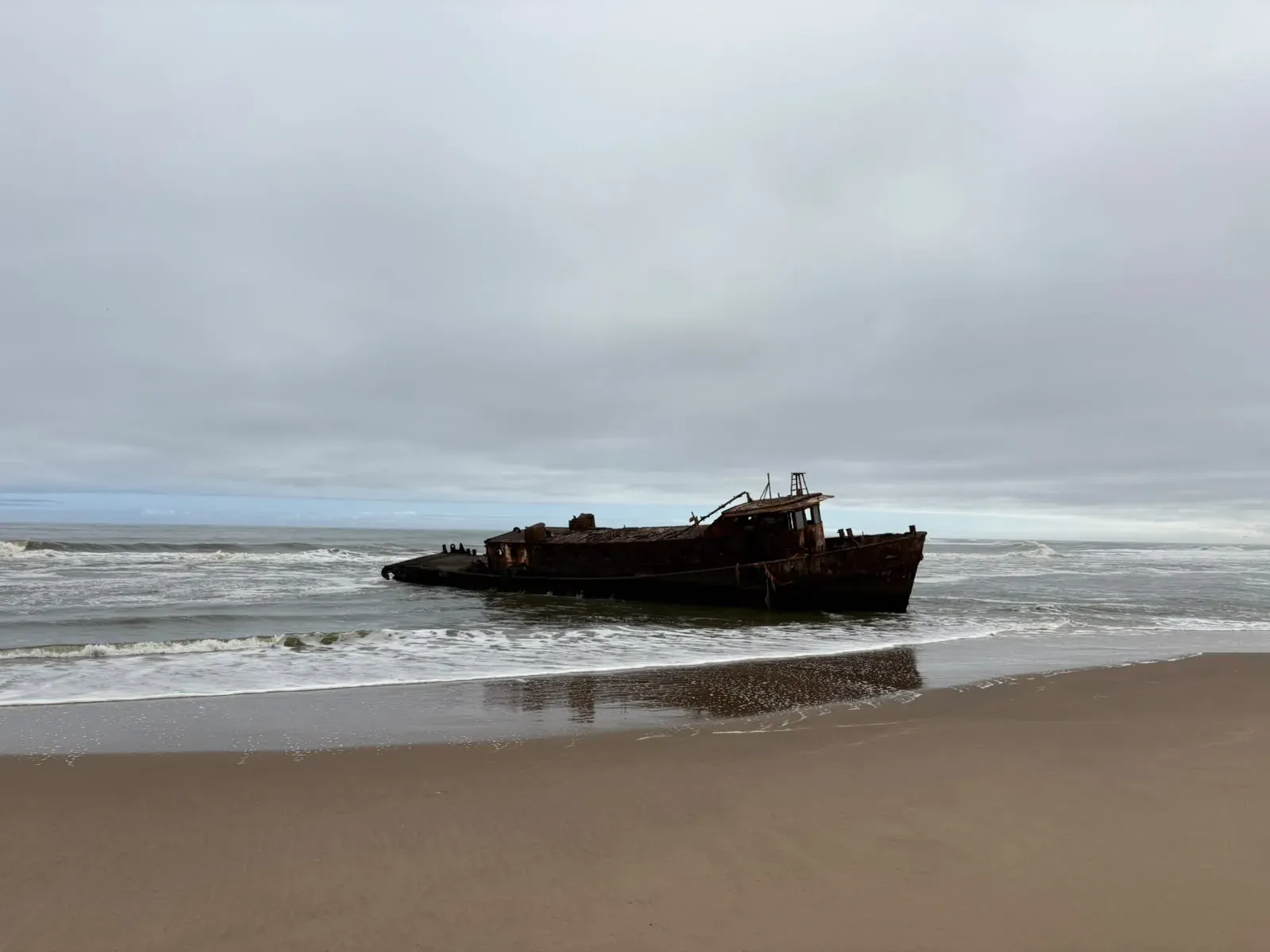 The rusting Shawnee trawler wreck in the cold Atlantic surf