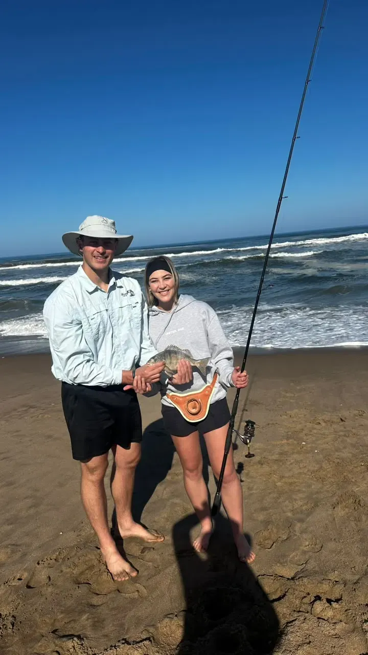 Young anglers with a fresh catch on the Atlantic beach
