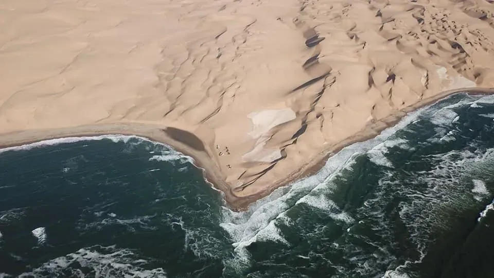 Aerial view of the dunes tumbling to the sea at Afklimbaai