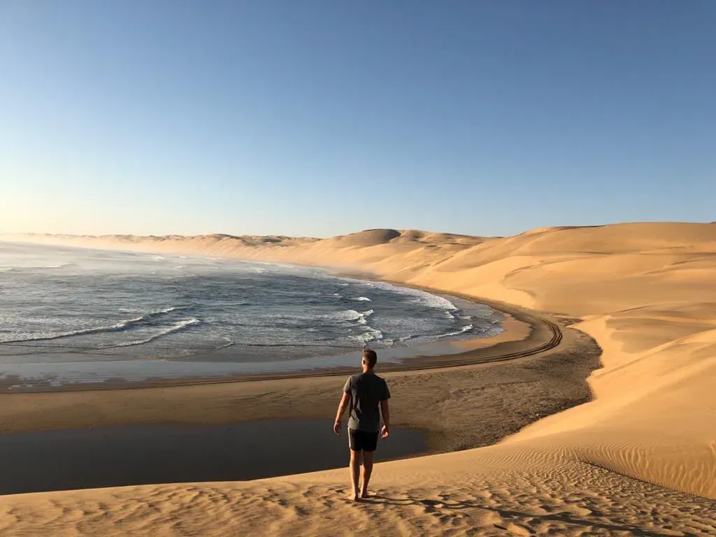 Looking down the dune face to the sea at Afklimbaai