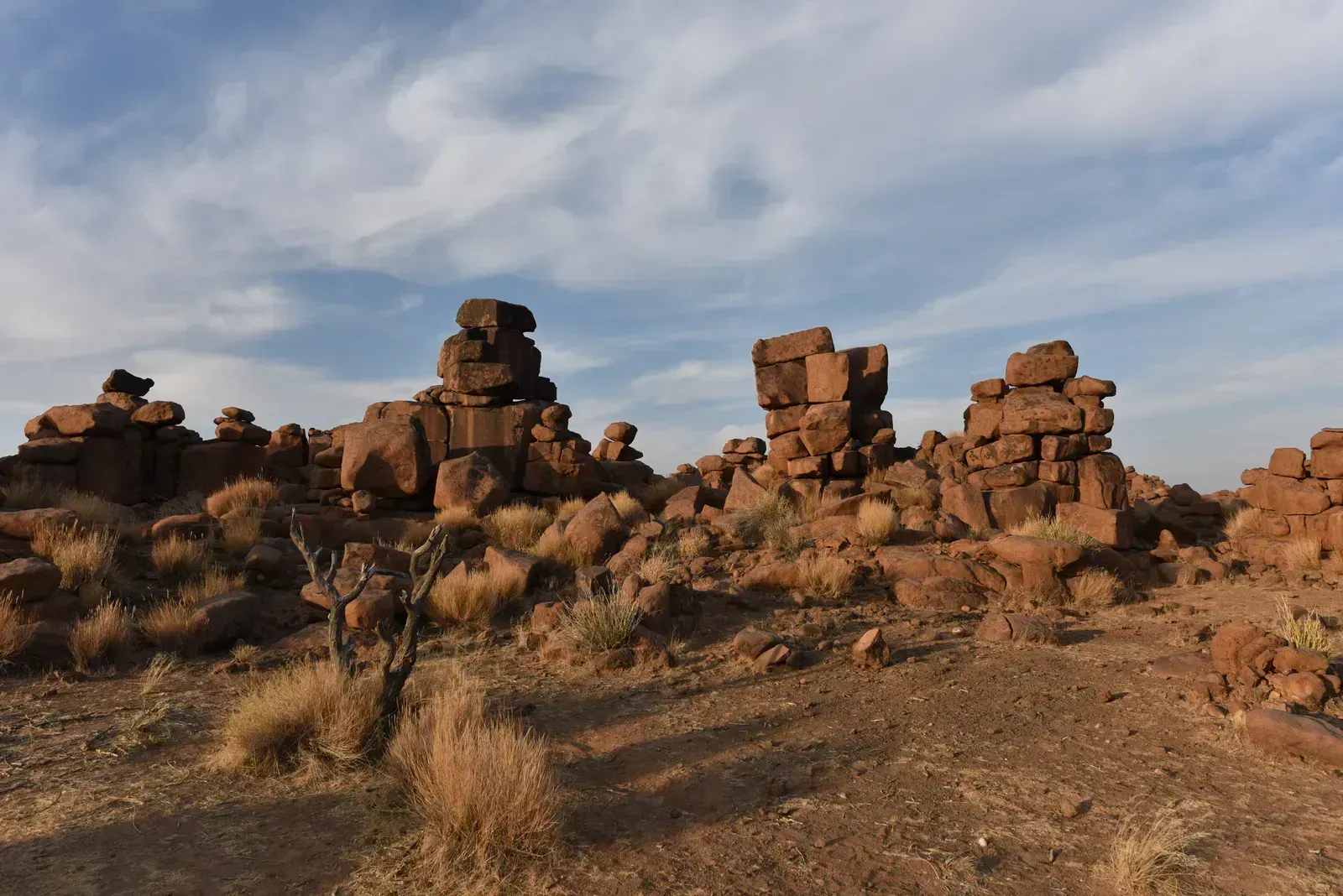 Stacked stone pillars form a maze under the wide Karas sky